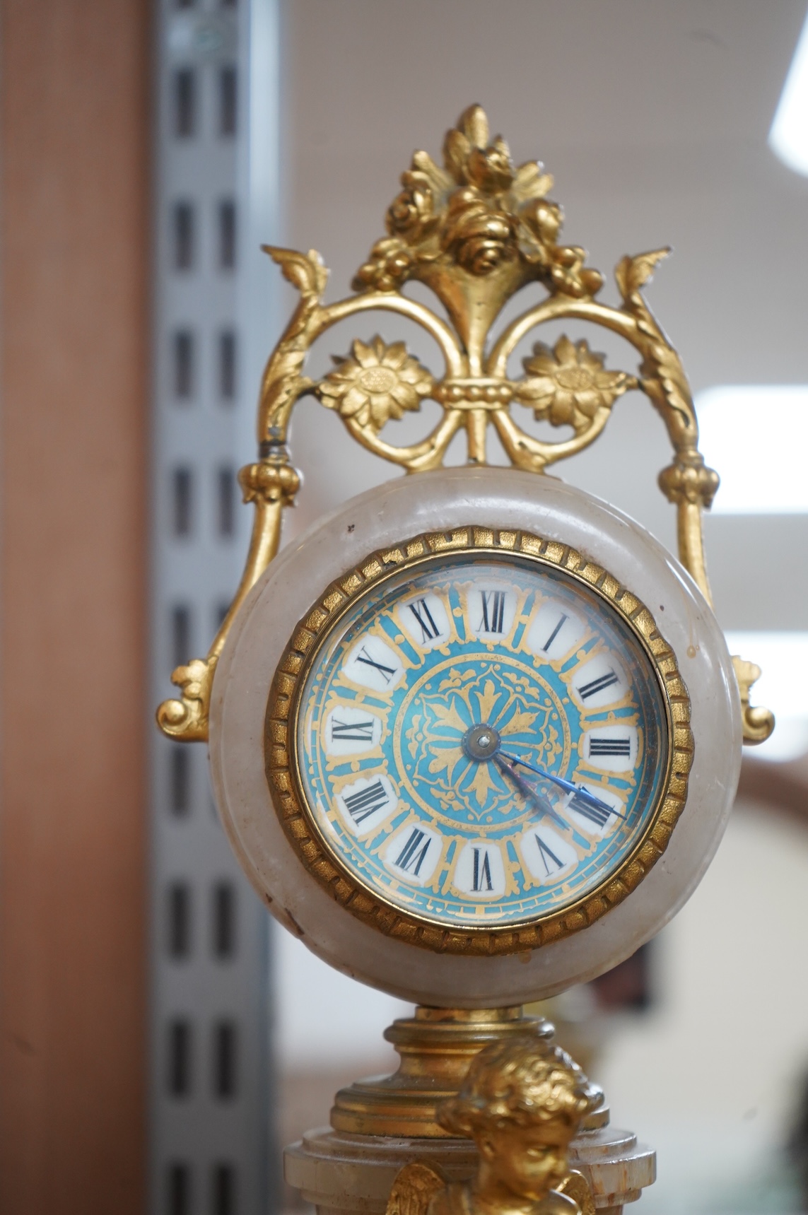 A late 19th century French ormolu and alabaster timepiece with painted dial and key, 24cm high